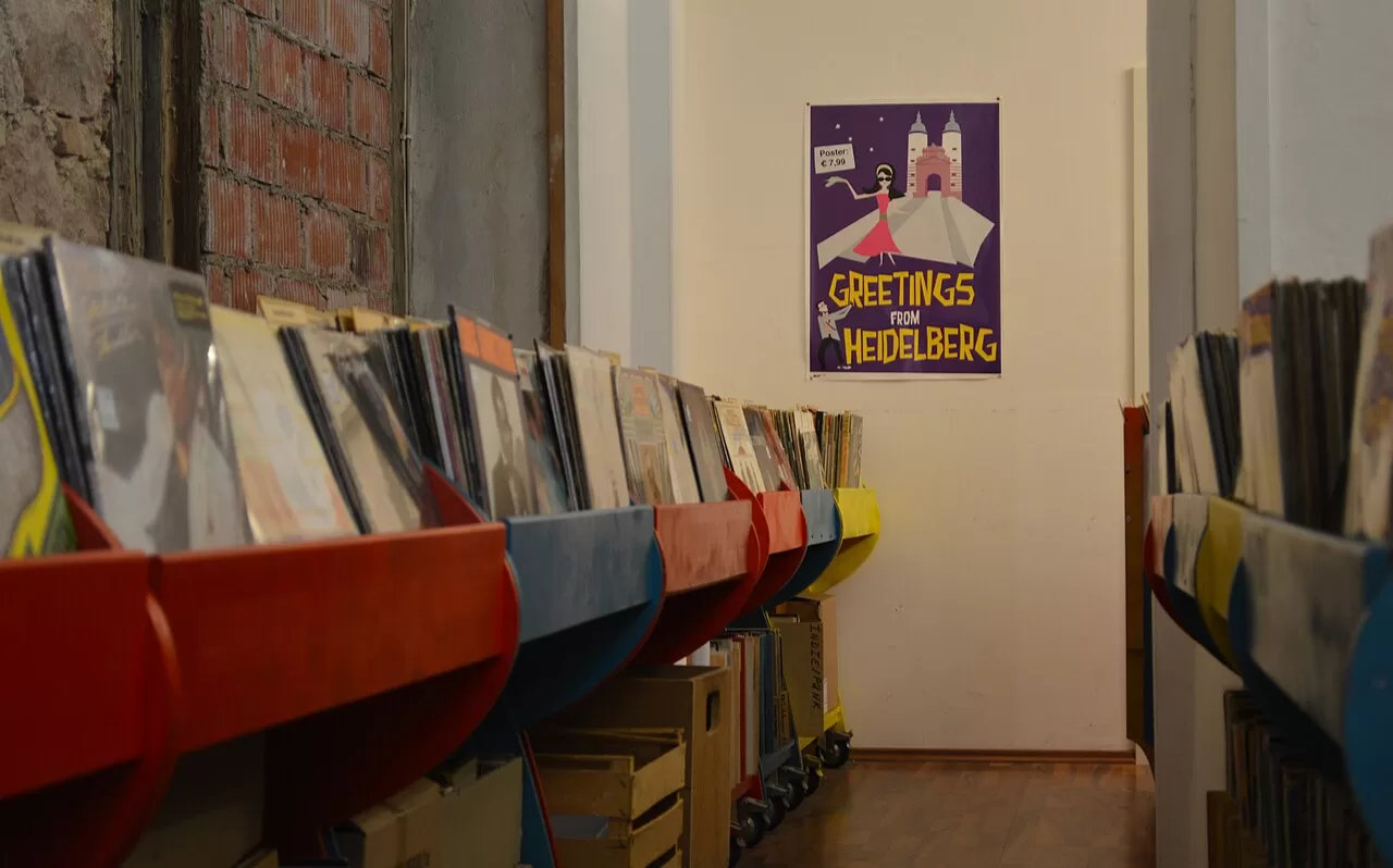 Rows of vinyl records in coloured display bins in a Heidelberg record shop