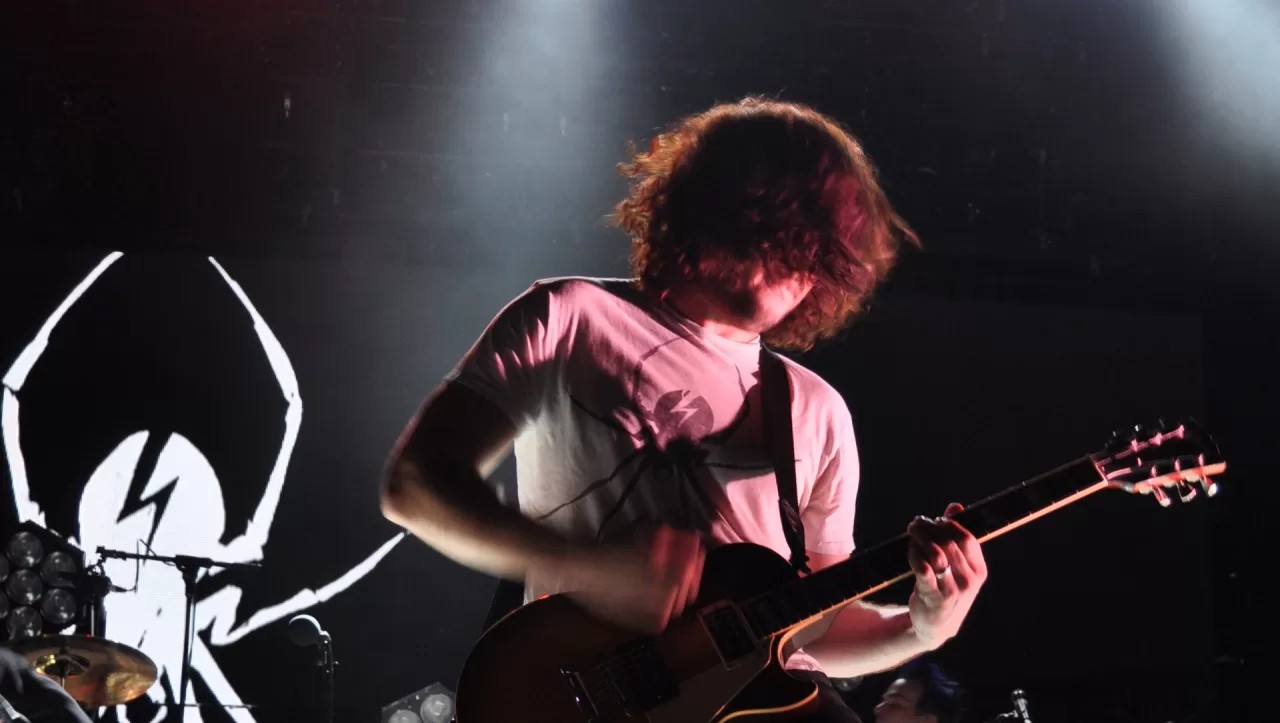 My Chemical Romance guitarist Ray Toro playing a black guitar on stage in 2011
