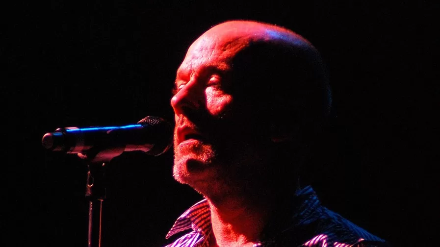 Michael Stipe singing into a microphone during a 2008 R.E.M. concert in Manchester