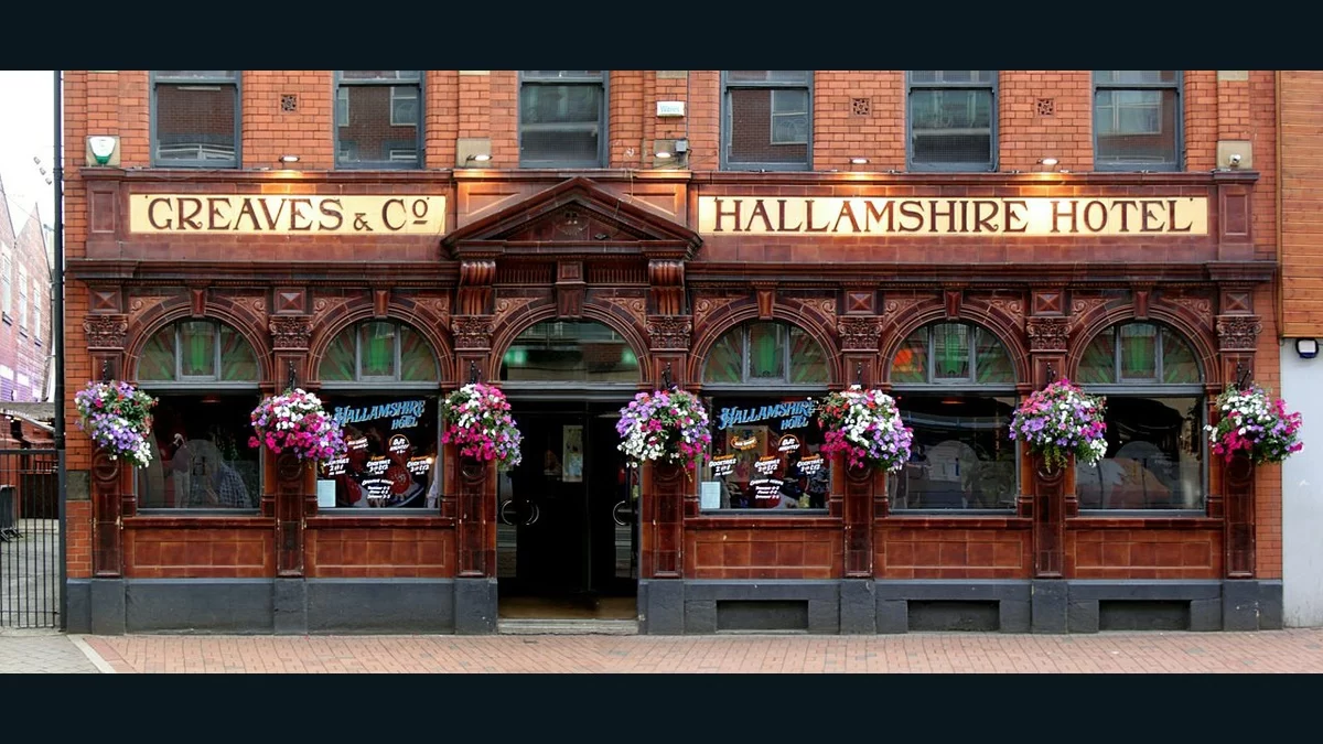 The Hallamshire Hotel’s red-brick pub facade and sign on West Street in Sheffield