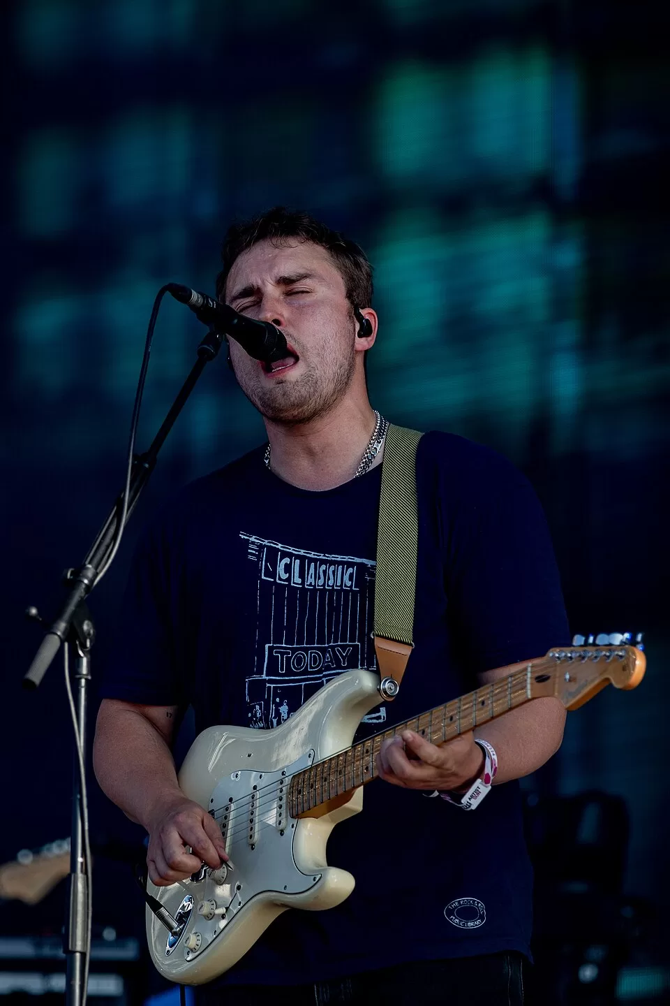 Sam Fender singing and playing a white electric guitar at Southside Festival in 2025