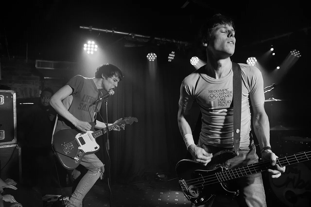 The Cribs performing with guitar and bass on a concert stage in 2018