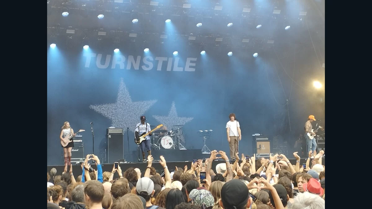 Turnstile performing beneath the band’s stage backdrop at Rock en Seine in 2023