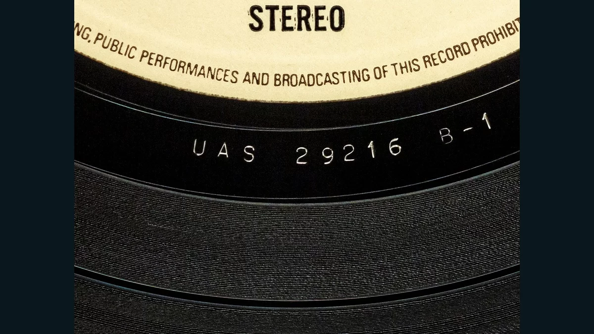 Etched UAS 29216 B-1 matrix code between a vinyl record’s label and grooves